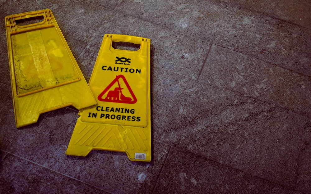 sign reads: "Caution Cleaning In Progress"