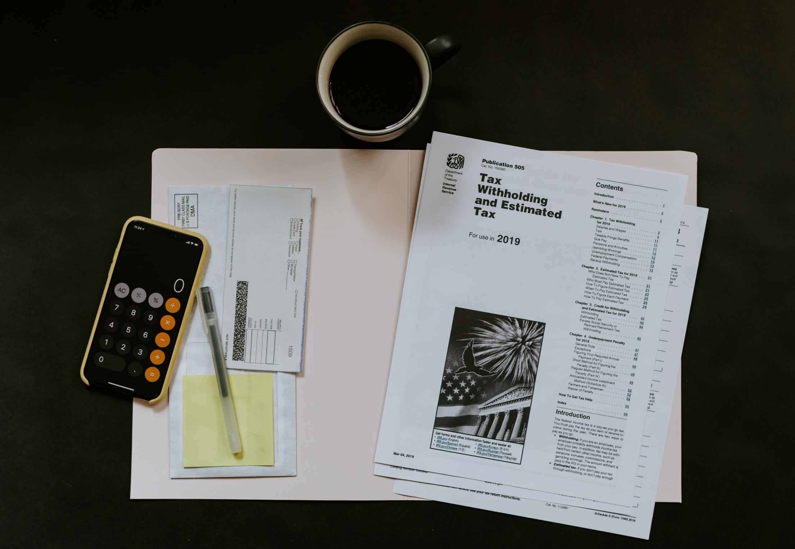 US tax forms and a calculator on a table.