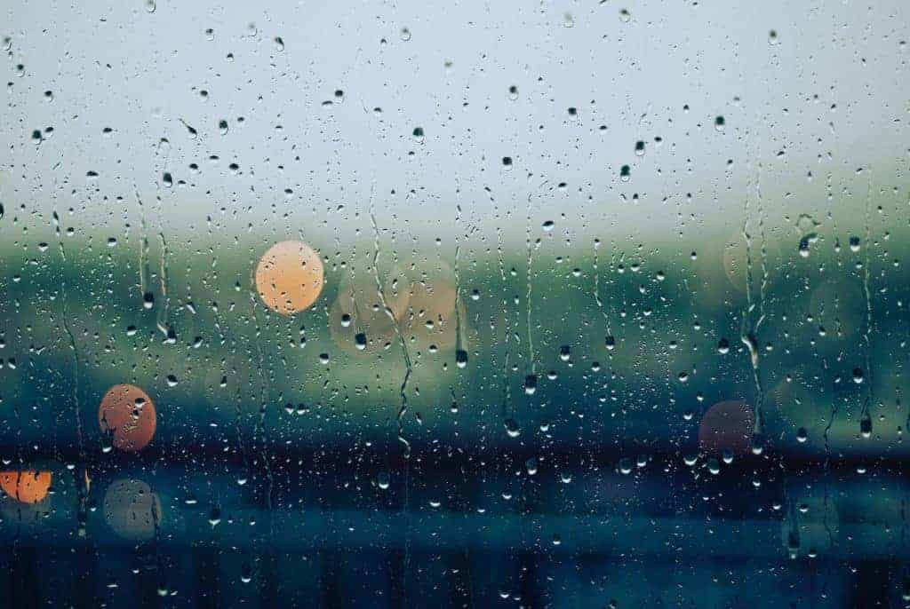 A glass window with raindrops on it.