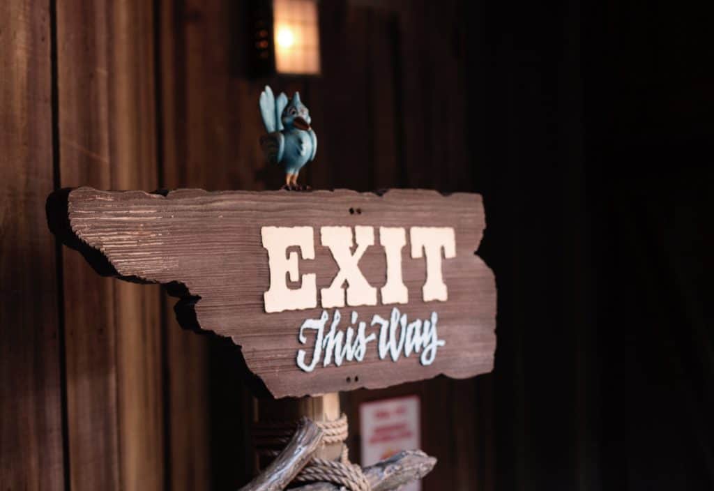 Wooden sign with text: "Exit This way"