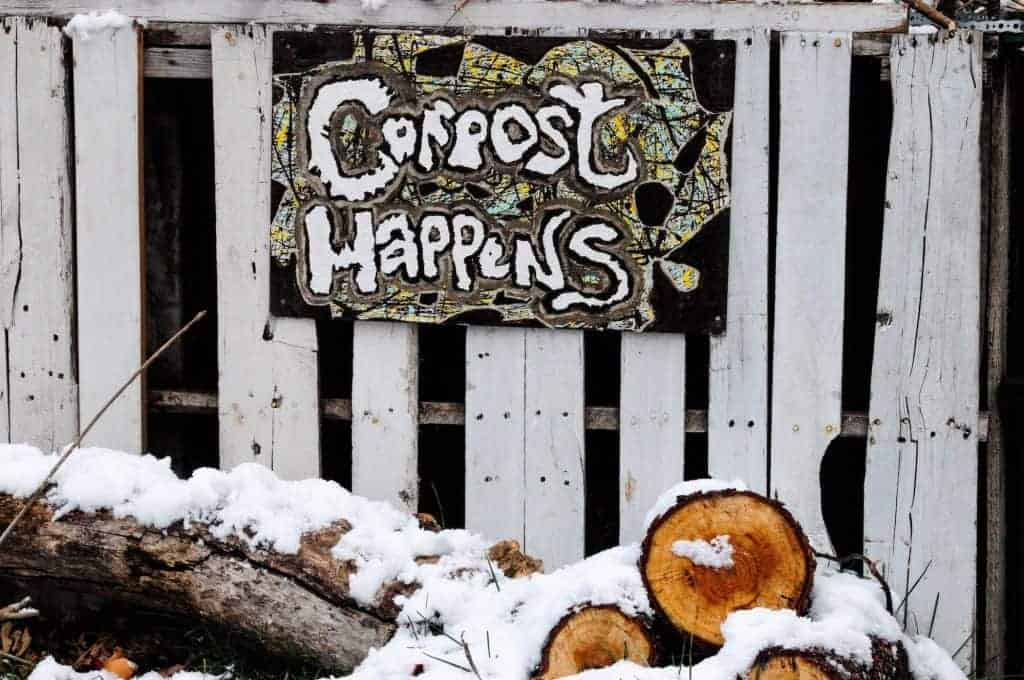 A hand-written outdoor sign that reads "Compost Happens"