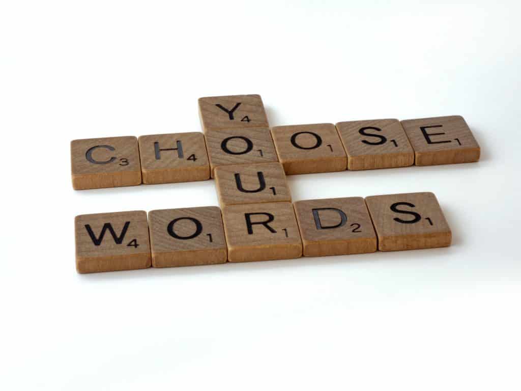 scrabble tiles that spell out "Choose your words"