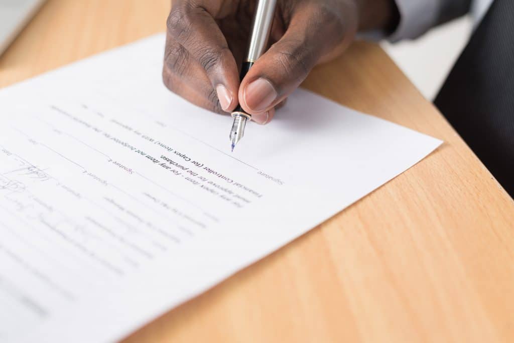 man signing contract <span>Photo by <a href="https://unsplash.com/@cytonn_photography?utm_source=unsplash&utm_medium=referral&utm_content=creditCopyText">Cytonn Photography</a> on <a href="https://unsplash.com/s/photos/paper-and-pen?utm_source=unsplash&utm_medium=referral&utm_content=creditCopyText">Unsplash</a></span>