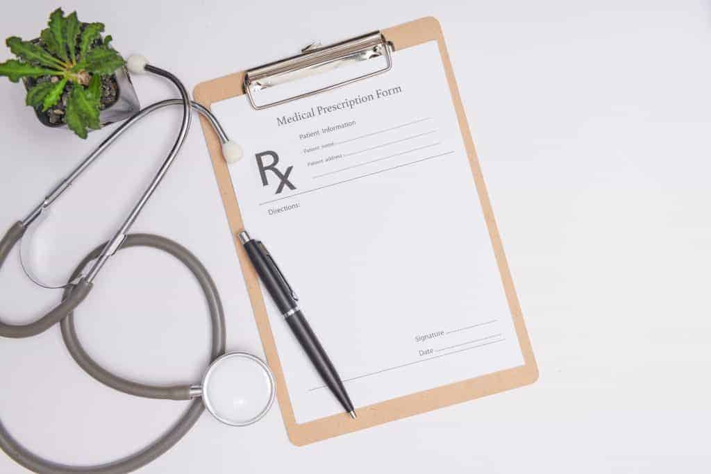 prescription pad, pen, and stethoscope