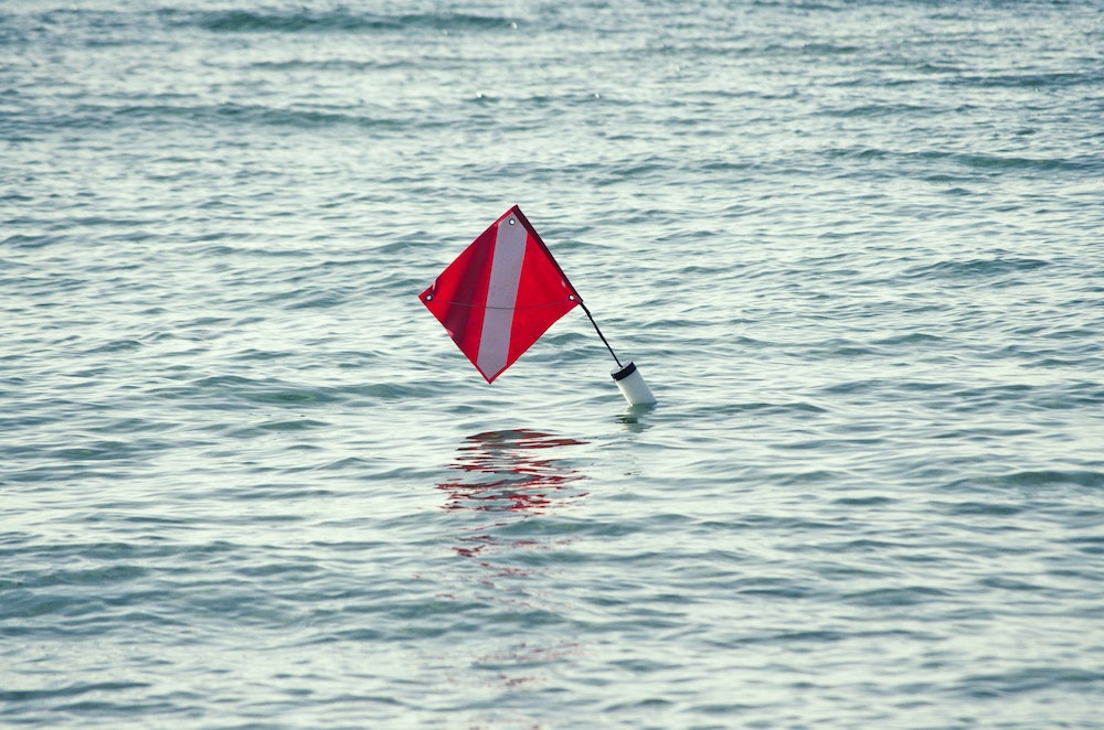 a caution flag in water