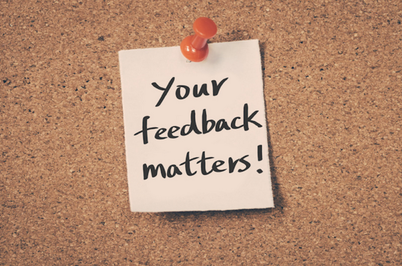 post it that reads, "Your feedback matters!" pinned to corkboard
