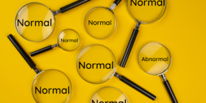 A yellow banner with eight magnifying glasses of different sizes containing the word "normal". One contains the word "abnormal".