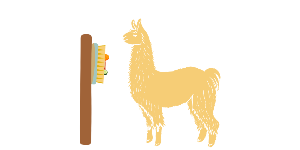 A yellow cartoon llama stands in front of a wooden post with a large broom brush attached to it containing carrots, strawberries and cucumbers.