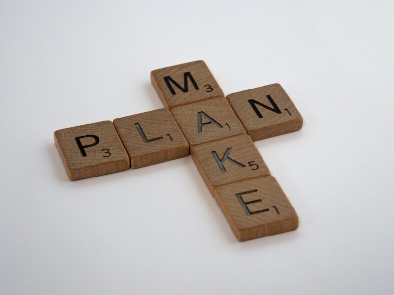 scrabble letters spelling out "make" and "plan"