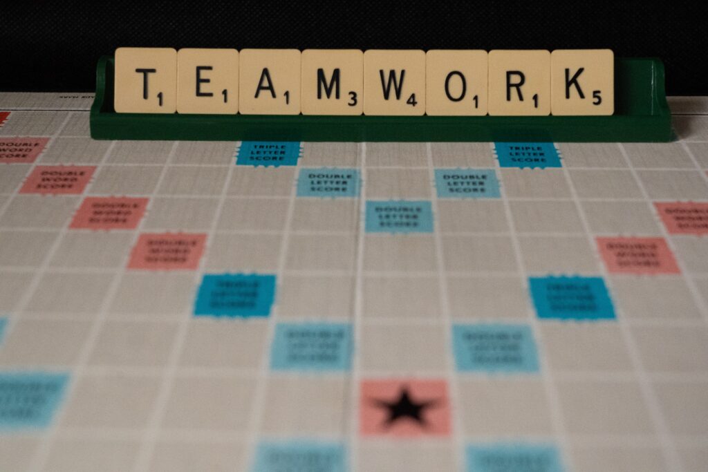 An image of a game board, with game tiles with letters. The letters spell out "teamwork." 
