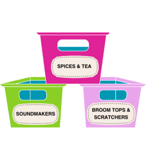 Three containers, one green, one magenta, and one lilac bear labels stating "spices and tea", another with "Broom Tops And Scratchers", and another with "Soundmakers" on the front.