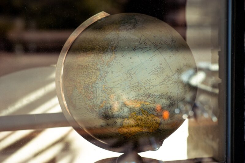 light reflects off a window in front of a globe