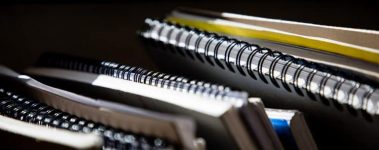 spiral bound notebooks stacked together