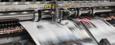 An image of a printing press printing newspapers.