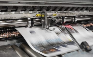 An image of a printing press printing newspapers.