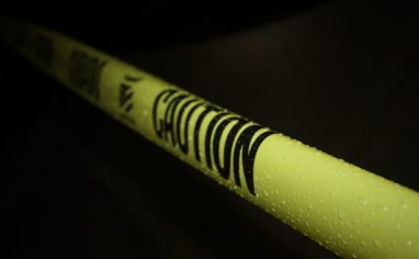 caution tape stretched across blackness